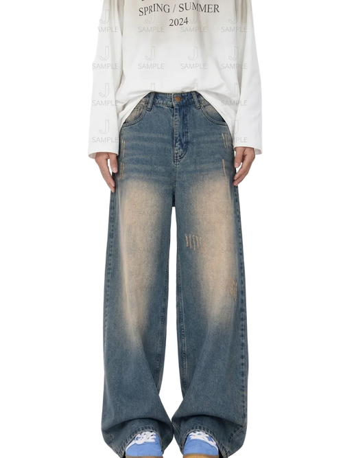 A person wearing wide-leg faded blue denim jeans with a white long-sleeve shirt and blue sneakers, standing against a white background with a repeating watermark pattern.
